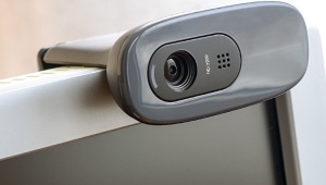 How do I connect and configure a webcam to my computer?